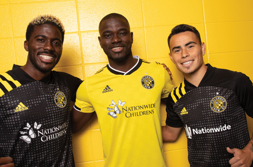 SCORE: Columbus Crew SC players, from left, Gyasi Zardes, Jonathan Mensah and Lucas Zelarayan, wear their new jerseys featuring Nationwide and Nationwide Children’s Hospital logos. Photo courtesy of Columbus Crew SC. Photo by Alex Brown.