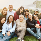 group of people sitting in the grass