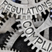 Image of gears with words regulation and compliance